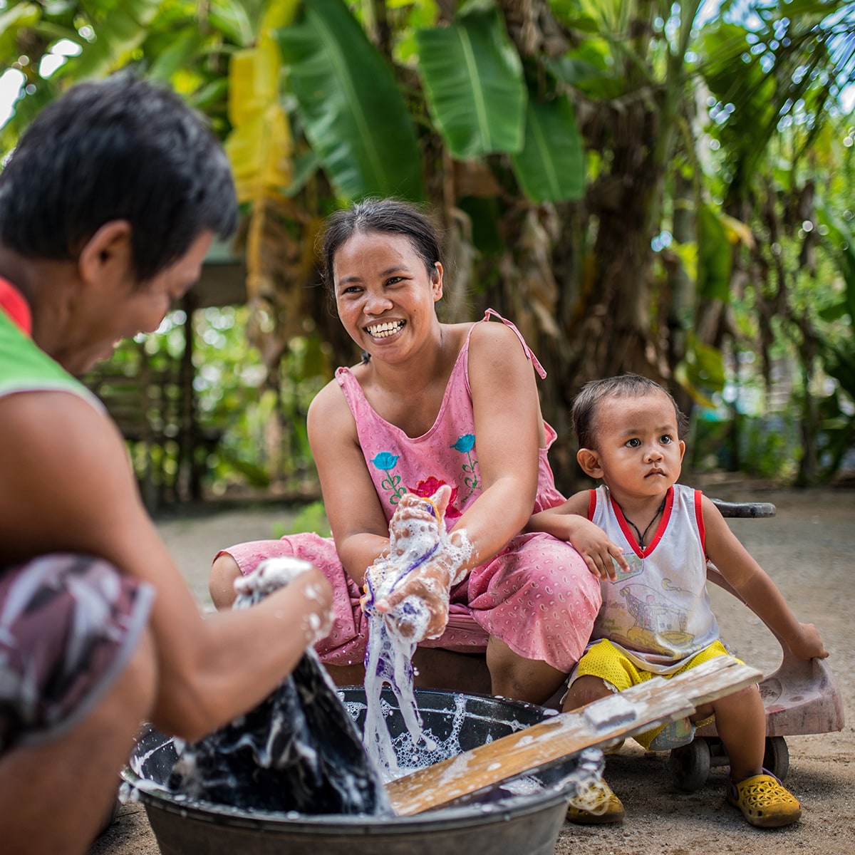 A woman and her child doing laundry