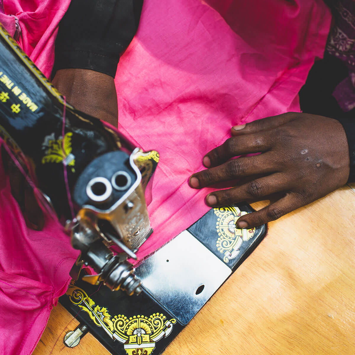 A close up of someone working at a sewing machine